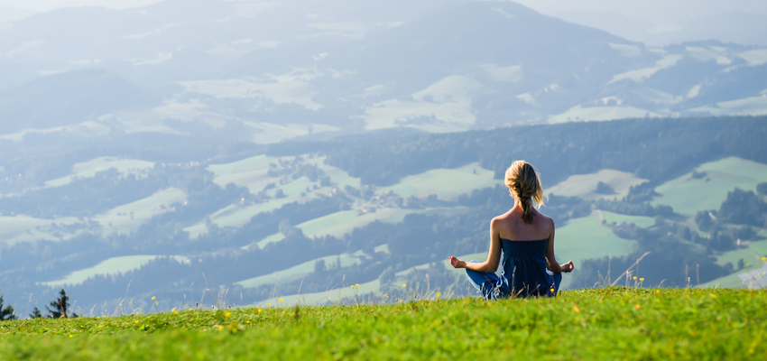 woman-meditating-mountain-green-blue-her